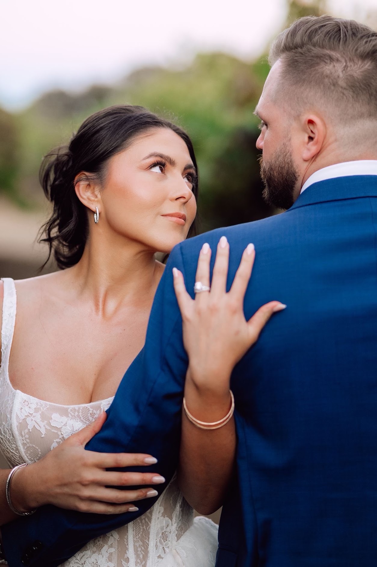 Bride looking at her groom on her wedding day with soft glam makeup by Maddy Donohue